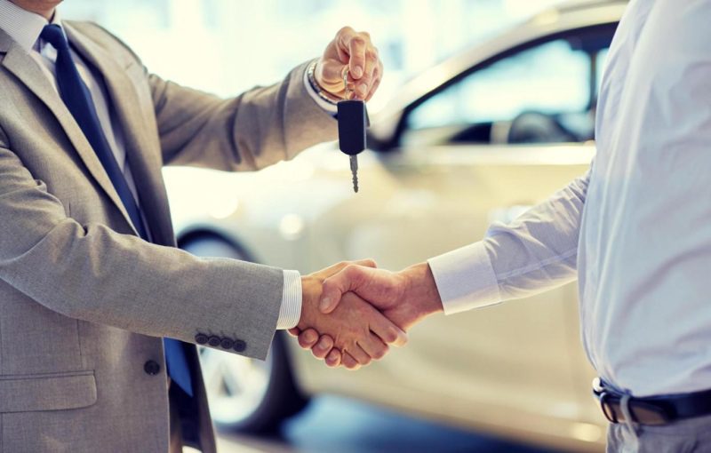 Handing over car keys to new lease car