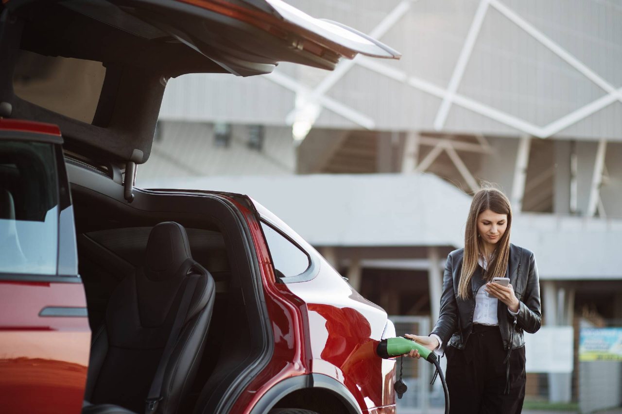 Female driver charging her Tesla on a Fleet Alliance salary sacrifice scheme 1280px