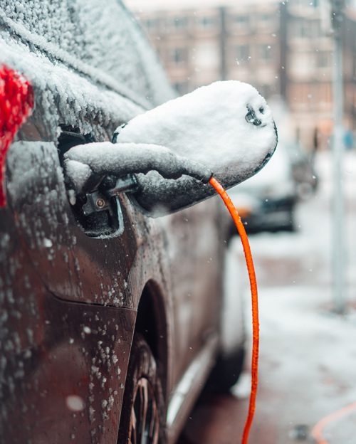 Electric car charging in the snow